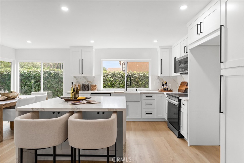 3621 Myrtle Street Irvine, CA 92606 - Photo 21 of 40 a kitchen a sink a window and chairs