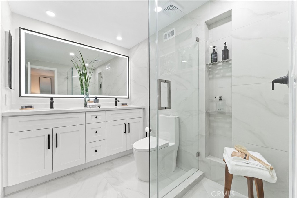3621 Myrtle Street Irvine, CA 92606 - Photo 27 of 40 a spacious bathroom with a double vanity sink mirror and toilet