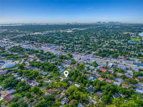 an aerial view of a house with a yard