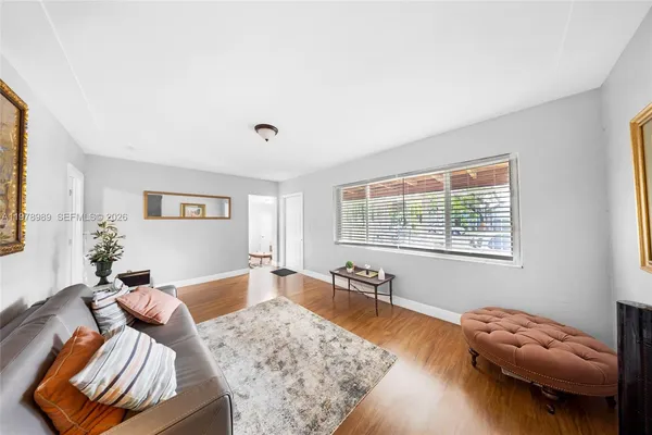 a kitchen with stainless steel appliances kitchen island granite countertop a stove refrigerator and cabinets