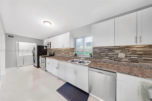 a living room with furniture a table and wooden floor