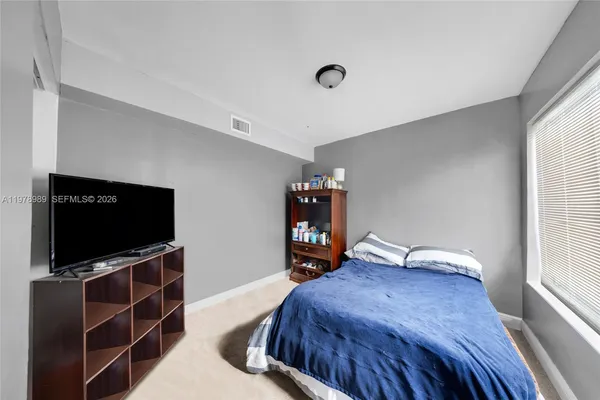 a bathroom with a sink a toilet and shower curtain
