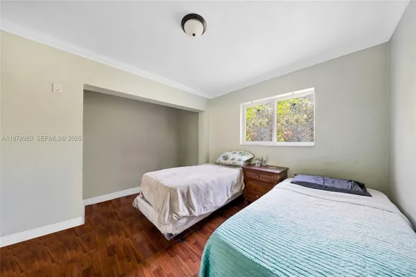 a bedroom with a bed a dresser and a bookshelf