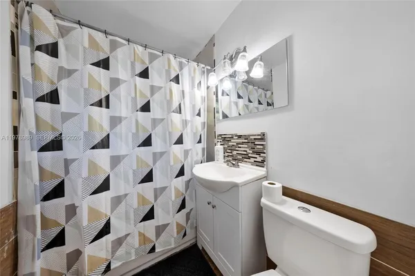 a bedroom with a bed and a view of kitchen