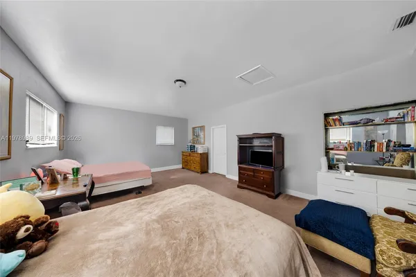 a house is sitting in middle od the grass