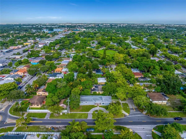 an aerial view of residential houses with outdoor space and street view