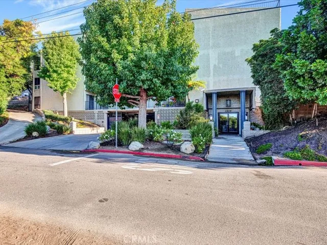 front view of a house with a yard and an trees