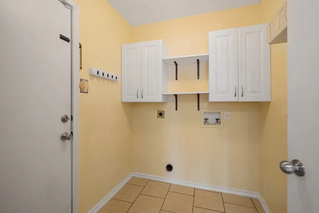 an empty room with wooden floor ceiling fan and windows