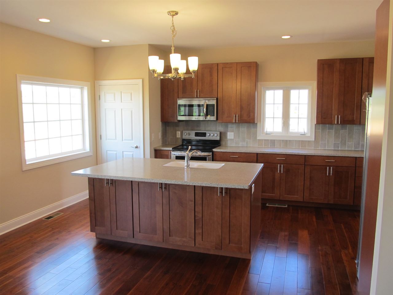 1055 Tinkling Spring Road Staunton, VA 24401 - Photo 13 of 36 a kitchen with stainless steel appliances a sink stove and wooden floor