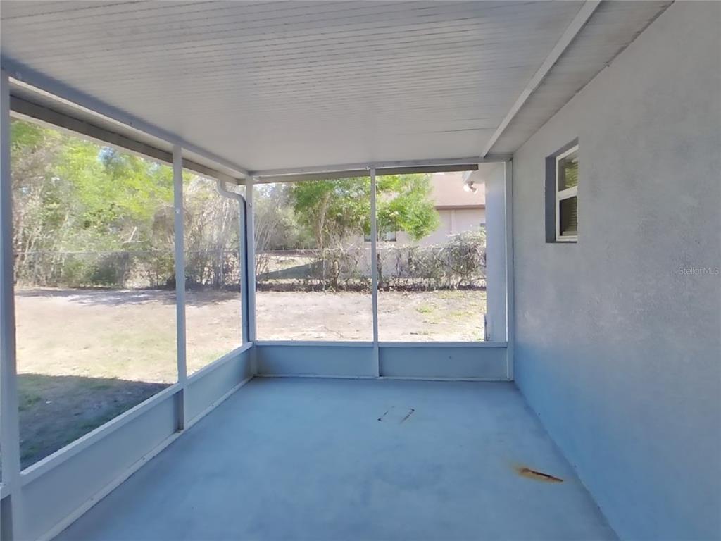 Undisclosed Address Spring Hill, FL 34609 - Photo 14 of 15 a view of an empty room with wooden floor and a window