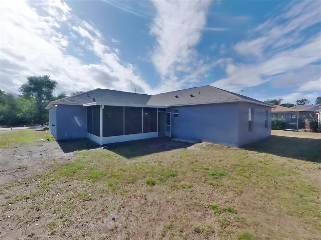 Undisclosed Address Spring Hill, FL 34609 - Photo 15 of 15 a house view with a backyard space