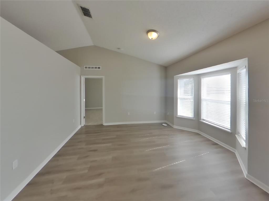 Undisclosed Address Spring Hill, FL 34609 - Photo 2 of 15 an empty room with windows