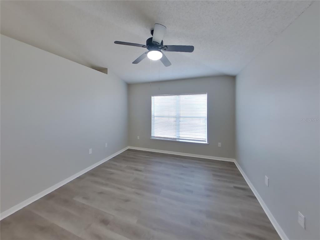 Undisclosed Address Spring Hill, FL 34609 - Photo 4 of 15 wooden floor in an empty room with a window