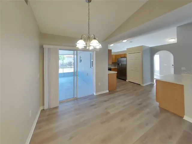 a view of a kitchen with a sink and a chandelier