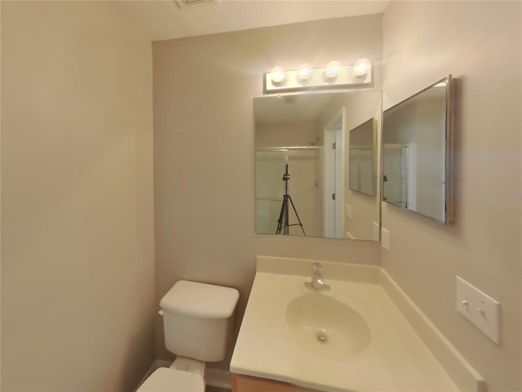 Undisclosed Address Spring Hill, FL 34609 - Photo 8 of 15 a bathroom with a sink a toilet and shower