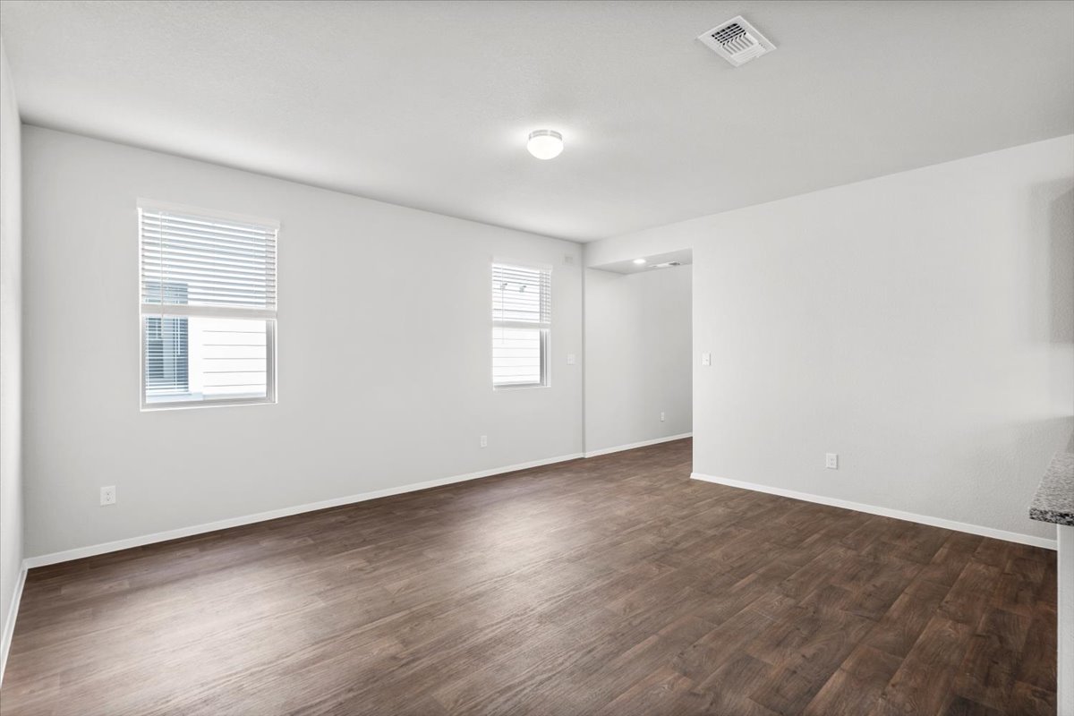 2607 Totley Road Manor, TX 78653 - Photo 11 of 40 Spare room featuring dark wood finished floors and baseboards