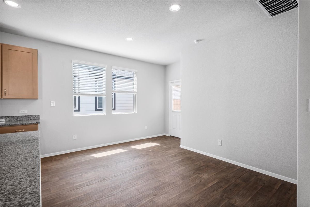 2607 Totley Road Manor, TX 78653 - Photo 12 of 40 Unfurnished living room with dark wood-style flooring and recessed lighting