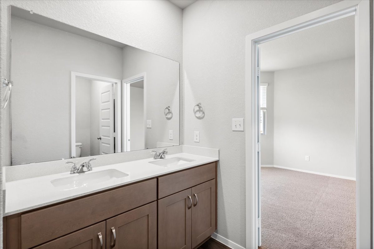 2607 Totley Road Manor, TX 78653 - Photo 18 of 40 Bathroom with double vanity and toilet