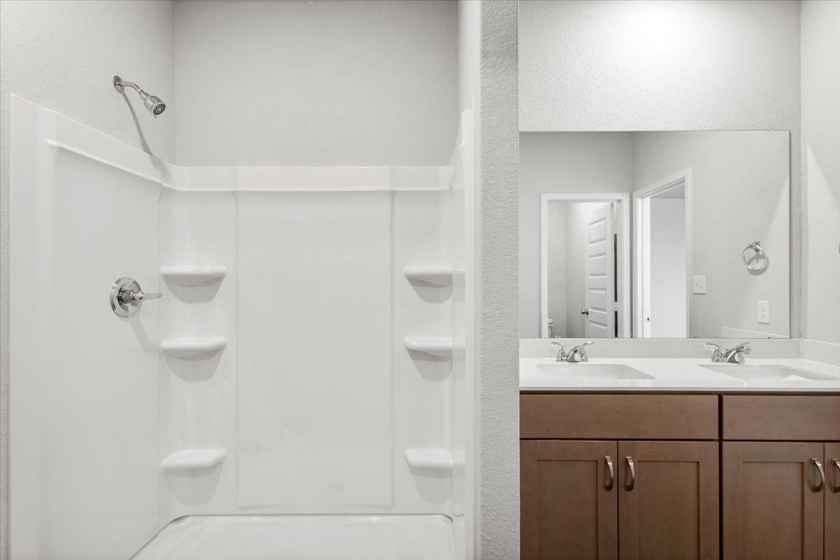 2607 Totley Road Manor, TX 78653 - Photo 19 of 40 Bathroom with double vanity and a shower