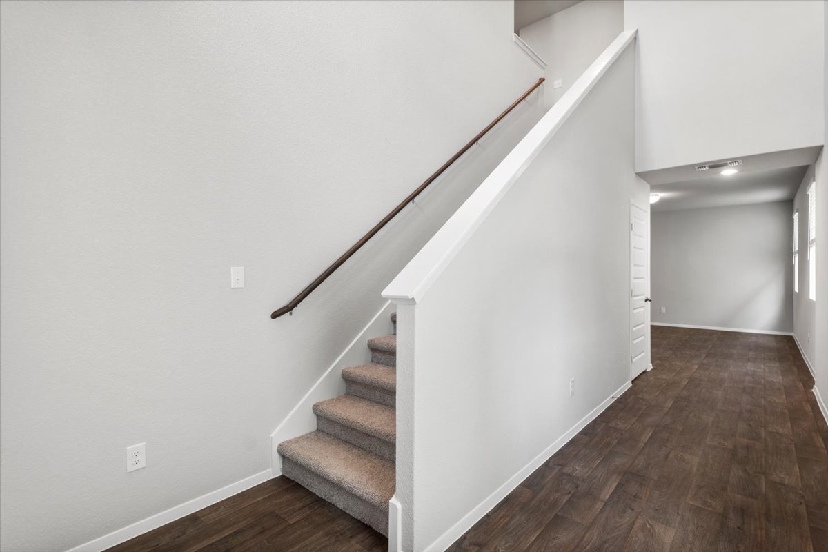 2607 Totley Road Manor, TX 78653 - Photo 21 of 40 Stairway with wood finished floors and baseboards