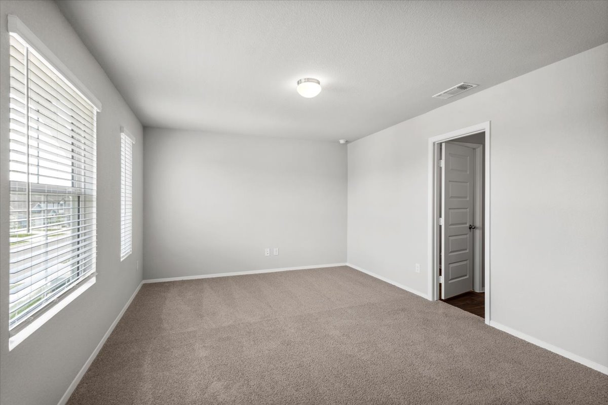 2607 Totley Road Manor, TX 78653 - Photo 24 of 40 Unfurnished room featuring dark colored carpet and baseboards