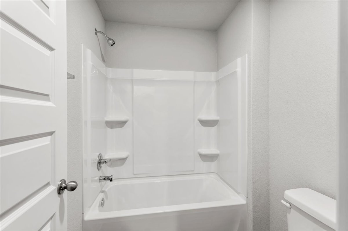 2607 Totley Road Manor, TX 78653 - Photo 26 of 40 Full bathroom featuring toilet and shower / bathtub combination