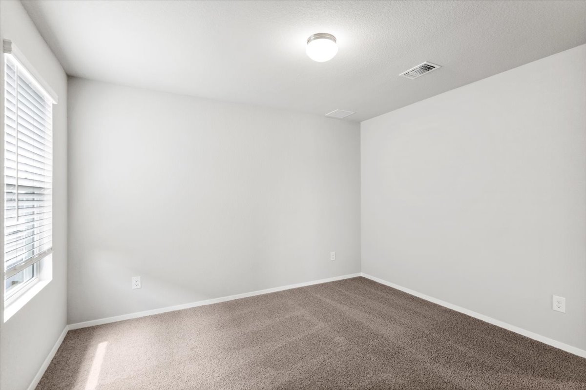 2607 Totley Road Manor, TX 78653 - Photo 28 of 40 Empty room featuring carpet flooring and baseboards