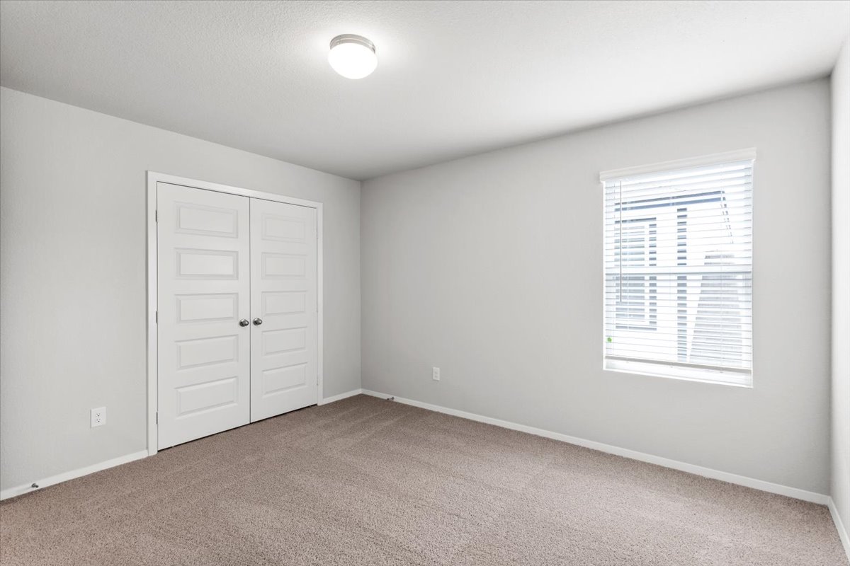 2607 Totley Road Manor, TX 78653 - Photo 32 of 40 Unfurnished bedroom with carpet flooring and a closet