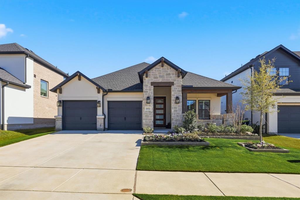 16912 Eastern Red Boulevard Justin, TX 76247 - Photo 1 of 22 a front view of a house with a yard and garage