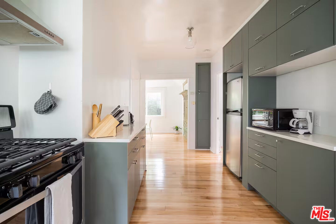 716 Sunset Avenue Venice, CA 90291 - Photo 4 of 13 a kitchen with stainless steel appliances granite countertop a stove and a refrigerator