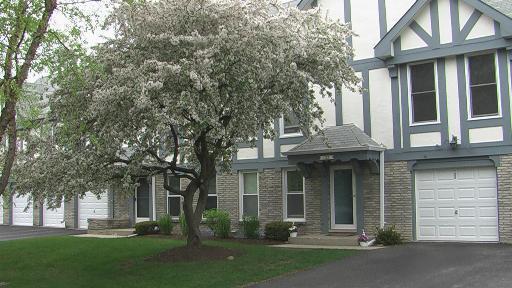 122 West Golf Road, Unit 122 Libertyville, IL 60048 - Photo 1 of 1 front view of a brick house with a yard