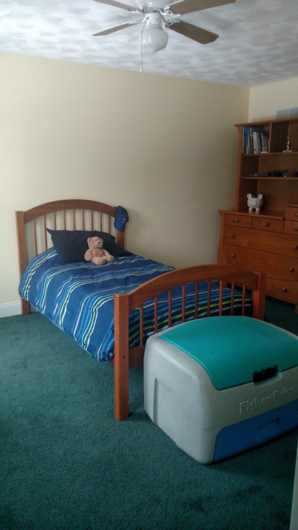 455 Hollis Road Lunenburg, MA 01462 - Photo 12 of 16 a bed sitting in a bedroom next to a larger window