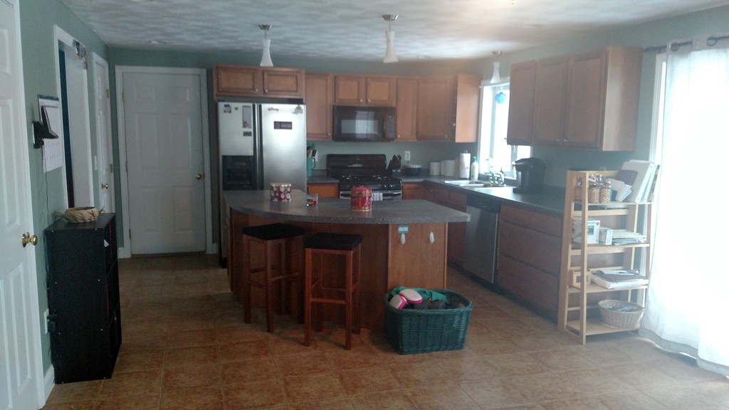 455 Hollis Road Lunenburg, MA 01462 - Photo 4 of 16 a kitchen with kitchen island a sink stove and refrigerator