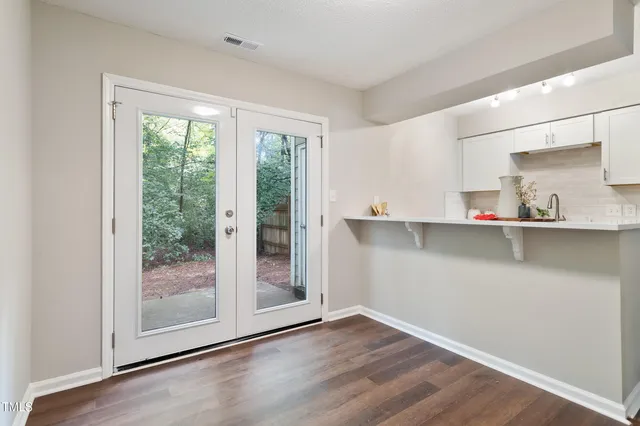 a kitchen with granite countertop a sink and a wooden floor