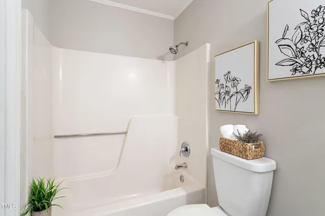 a bathroom with a toilet and a bathtub