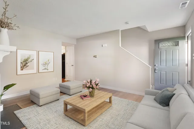 a living room with furniture and wooden floor