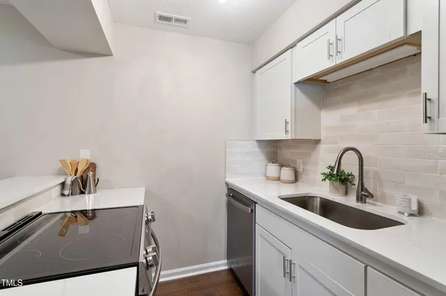a kitchen with a sink and cabinets