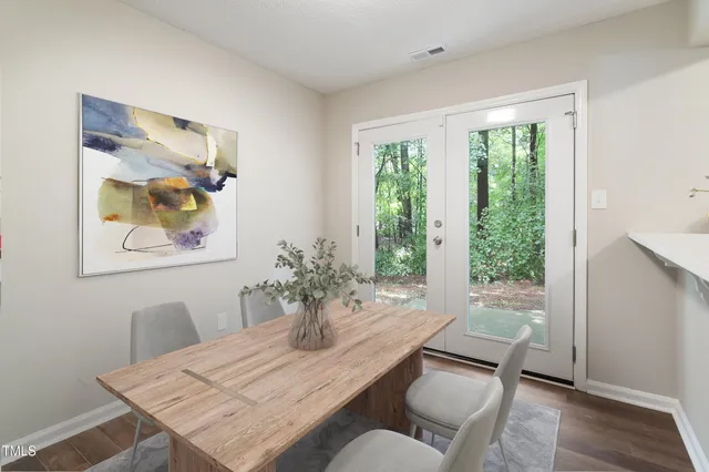 a dining room with furniture and wooden floor