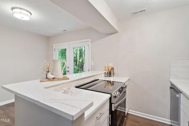 a kitchen that has a sink and a stove in it