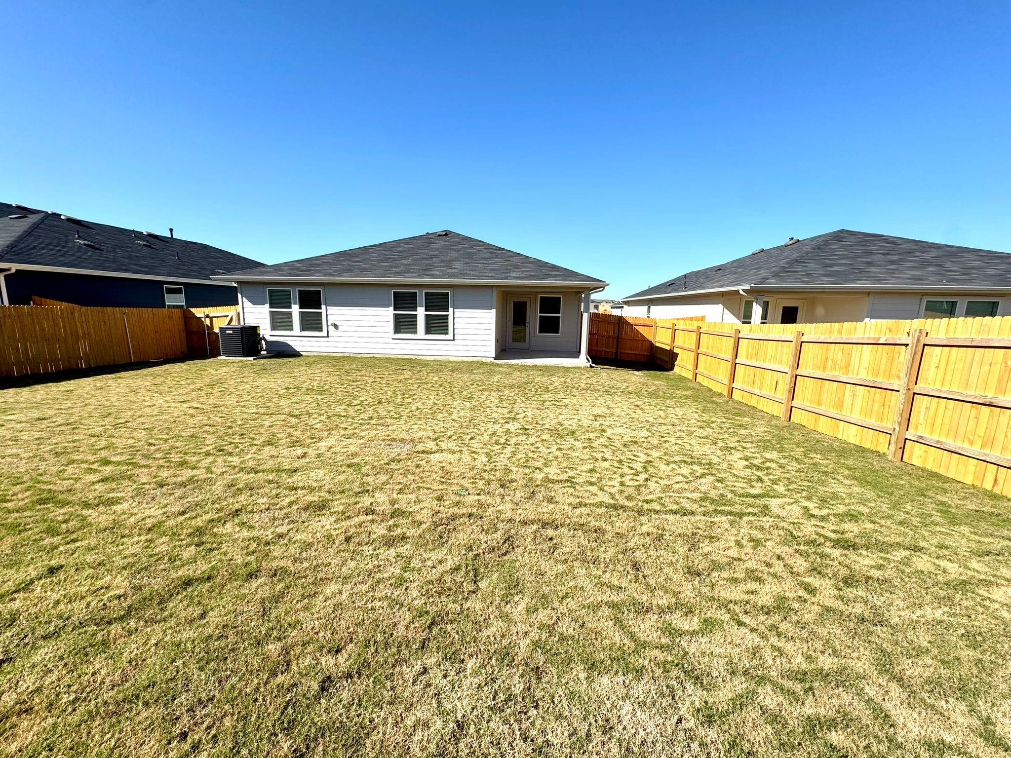 346 Gladiola Loop Kyle, TX 78640 - Photo 16 of 16 Rear view of house featuring a patio area and a fenced backyard