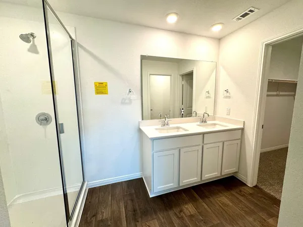 a bathroom with a double vanity sink and mirror