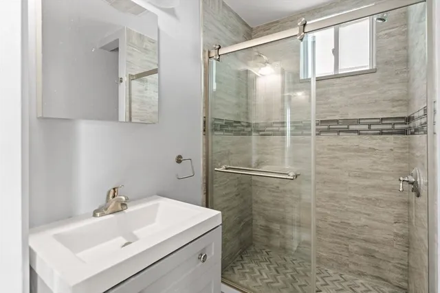 a bathroom with a shower and a sink