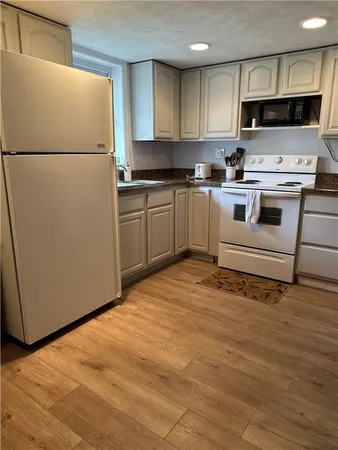 a white refrigerator freezer sitting in a kitchen