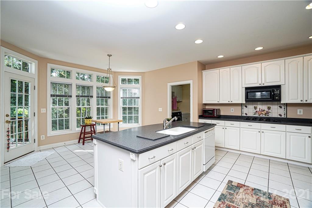 914 Chevis Court Fort Mill, SC 29708 - Photo 24 of 47 a kitchen with a sink stove and cabinets