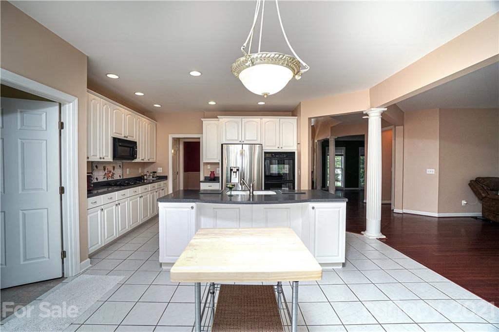914 Chevis Court Fort Mill, SC 29708 - Photo 26 of 47 a large kitchen with stainless steel appliances granite countertop a stove and white cabinets