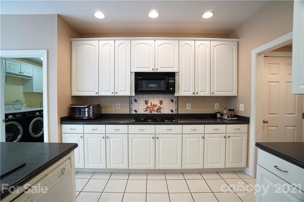 914 Chevis Court Fort Mill, SC 29708 - Photo 27 of 47 a kitchen with white cabinets and appliances