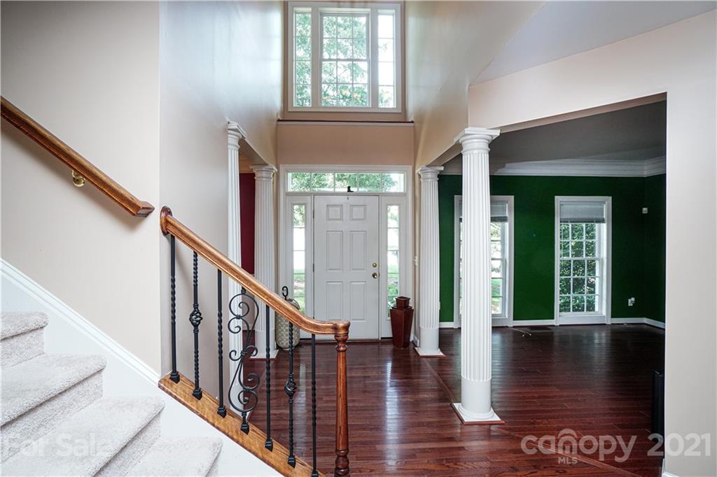 914 Chevis Court Fort Mill, SC 29708 - Photo 10 of 47 a view of a hallway with wooden floor and staircase