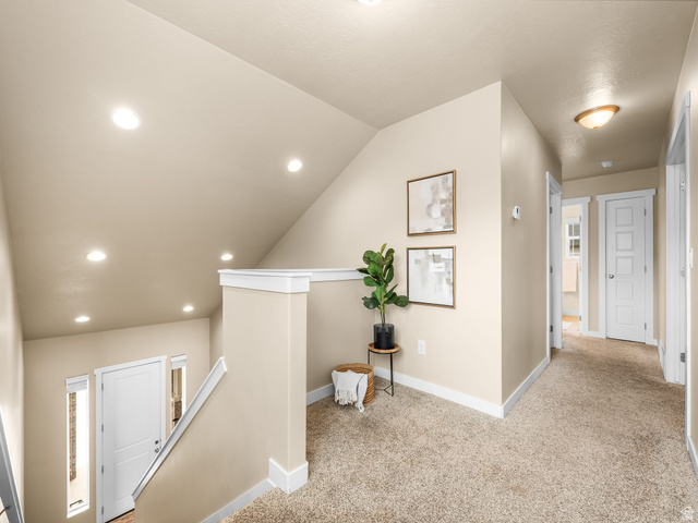 834 West 1050th Street South Springville, UT 84663 - Photo 11 of 26 Inviting upper landing featuring neutral-toned carpeting, recessed ceiling lighting, a contemporary white banister, and a white paneled door