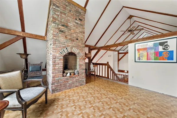a view of a hallway with furniture and a fireplace