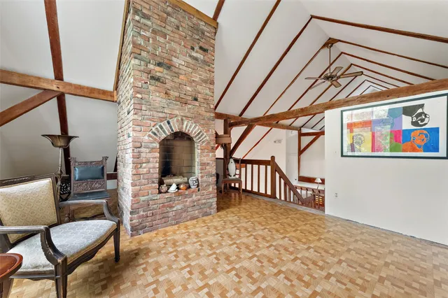 a view of a hallway with furniture and a fireplace
